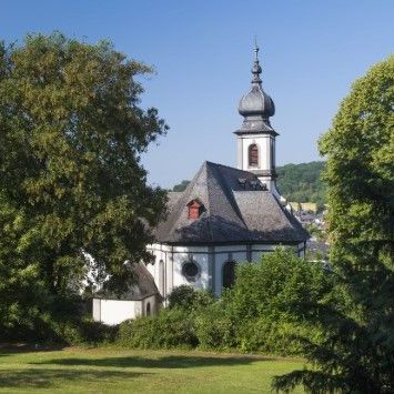Kirche mit zwei Bäumen auf der linken und rechten Seite
